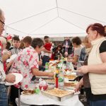 People lining up for food in the Polish tent.