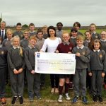 CORK: Pupils representing all the classes at Scoil Iosagain, Aghada making presentation of €1,071, the proceeds of various fundraising events at the shool, to Elaine Hill, Trócaire. Elaine thanked the pupils and teachers for their generosity and consideration for those people who are struggling to survive in poorer regions of the world. Included in photo is principal, Lawrence Collins. Photo: Mike English