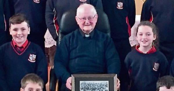 Pupils reunite priest with long-lost medals